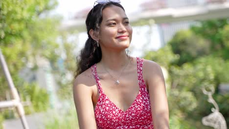 young woman smiling in a garden