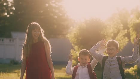 lady in red dress walks with schoolchildren throwing books