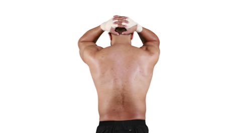 muscular man with his hands behind head