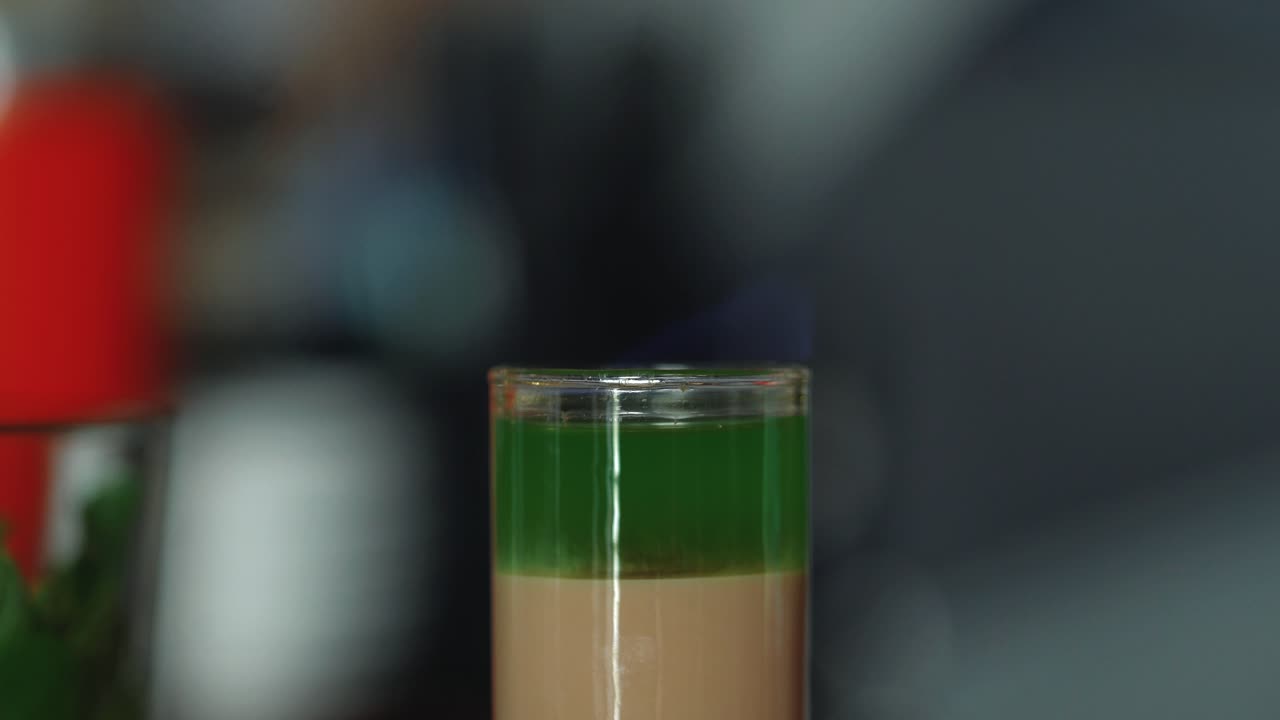 Barman prepares a cocktail and sets it on fire