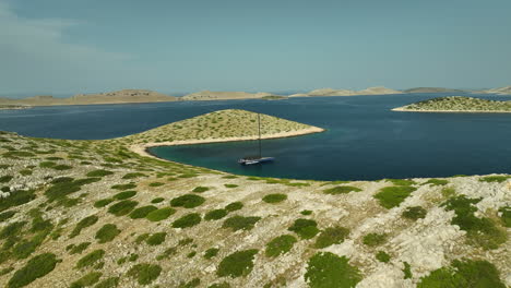 low angle drone panning shot of a luxurious sailing yacht moored in kornati national park