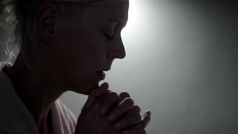 woman praying to god with hands together on grey background stock footage