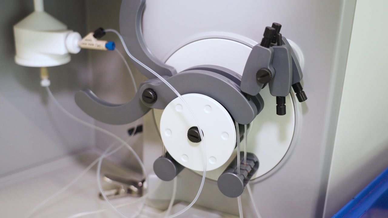 Laboratory pump with connected tubing inside a Chinese research facility, showcasing precision fluid handling equipment and scientific material testing technology, UHD