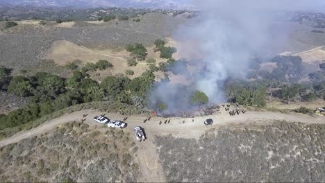 fire burns sagebrush at the top of a hill