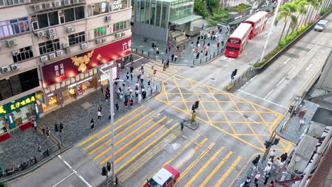 vehicles and pedestrians navigate a bustling intersection