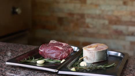 raw beef steak and fish ready to grill