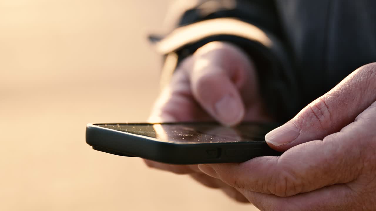 Closeup of female hands using mobile phone