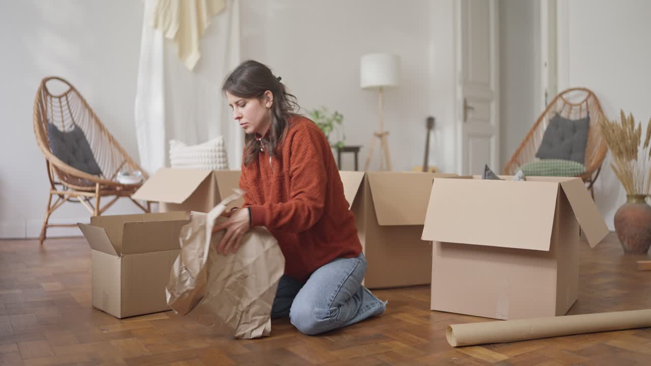 Woman unpacking boxes in a new home