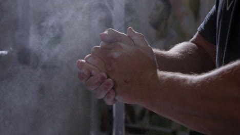 powerlifters rubbing hands with chalk close up