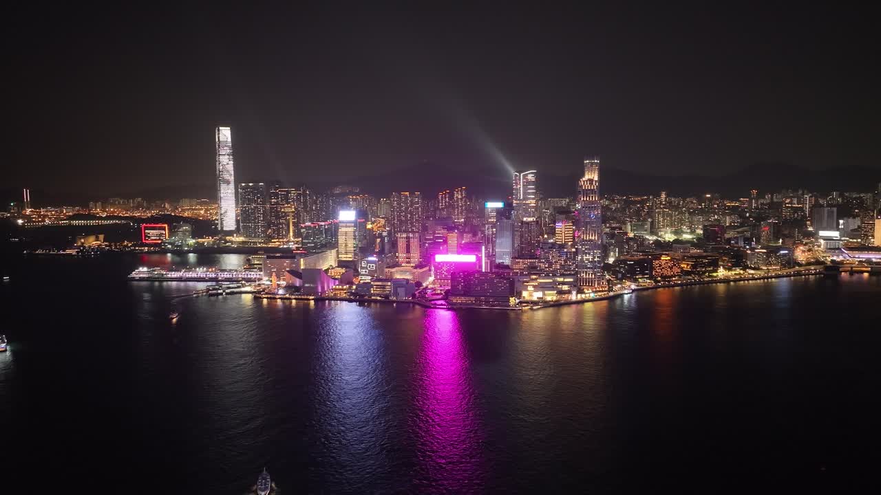 View of illuminated Downtown skyscraper during nighttime in Hong Kong. Aerial shot.