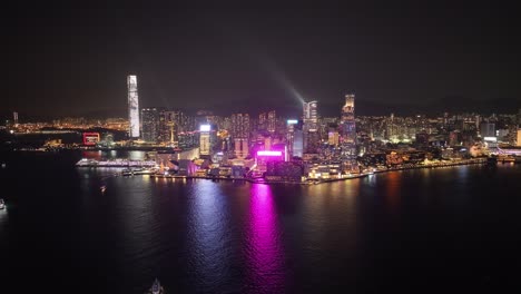 view of illuminated downtown skyscraper during nighttime in hong kong. aerial shot.