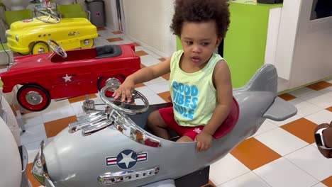 Happy-and-curious-two-year-old-african-european-child-waiting-for-his-turn-in-the-hairdresser´s