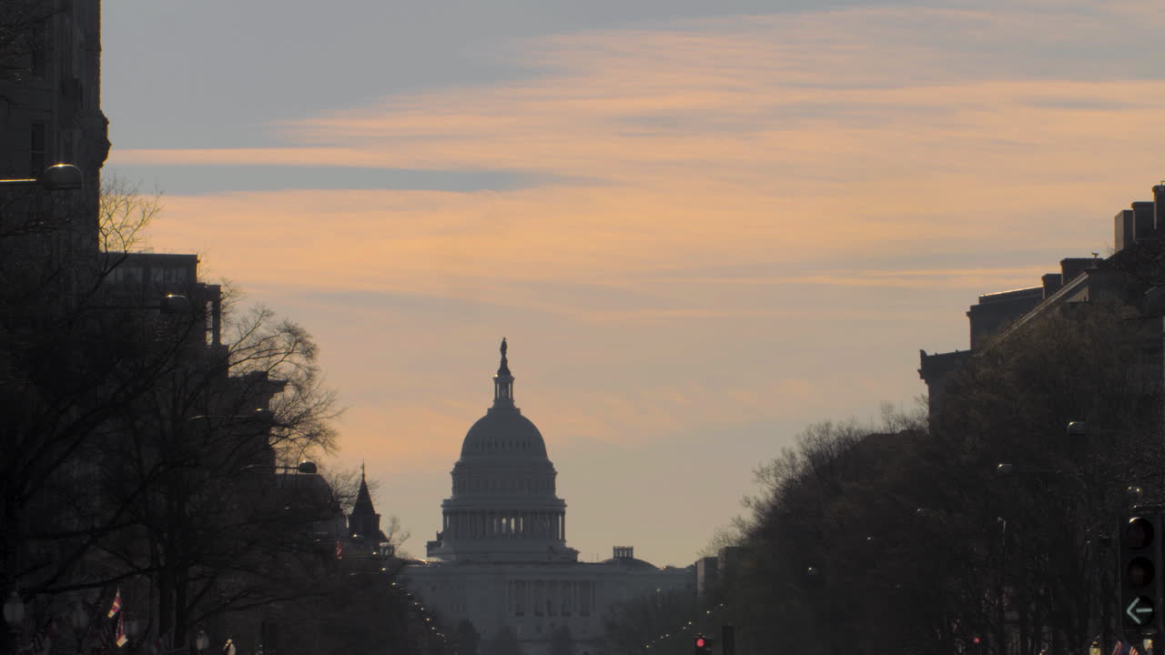US Capitol Dome in Silhouette with Orange Sunset Clouds Above