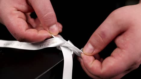 wrapping a gift box with a ribbon