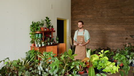 plant shop employee checking inventory