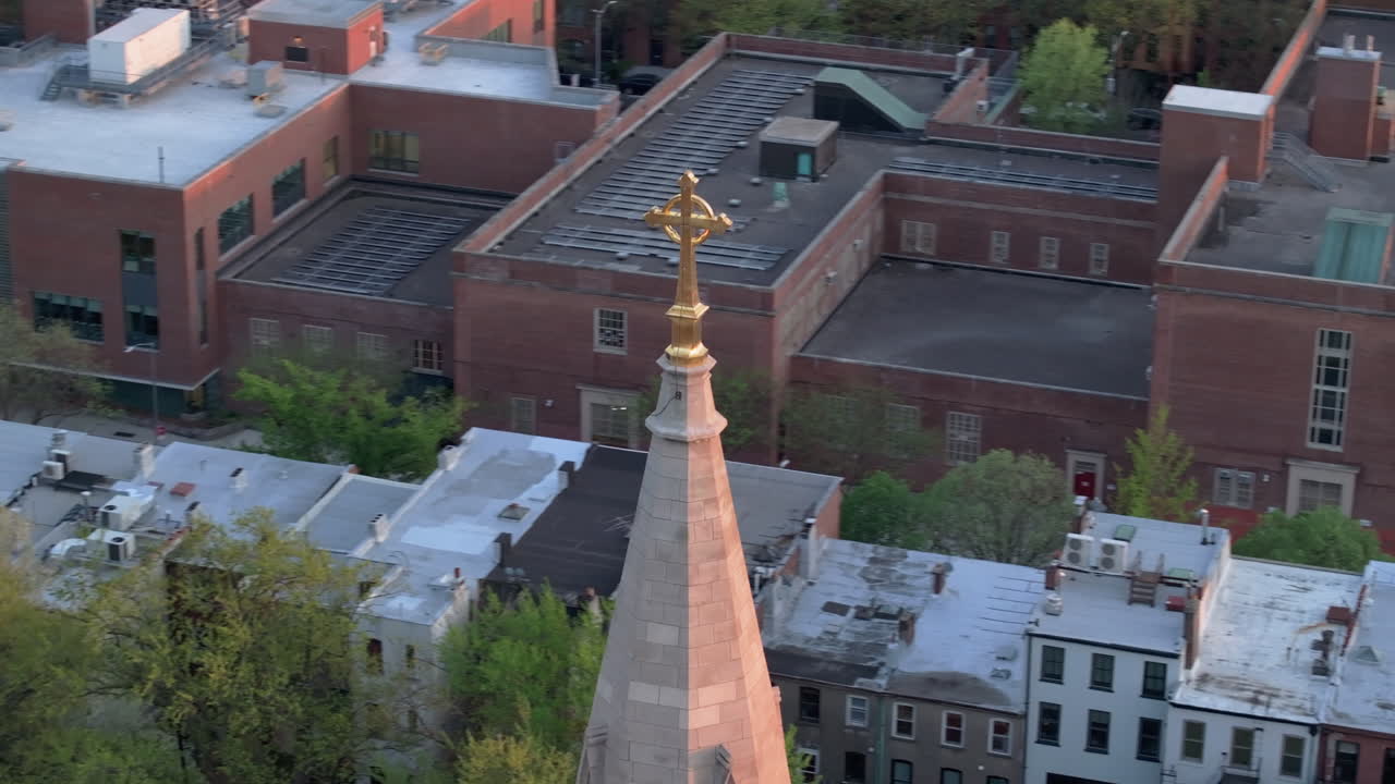 Aerial view of a crucifix on a church steeple in Brooklyn. Shot on a spring day.
