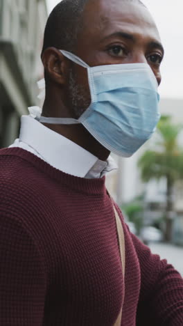 african american man on the go wearing coronavirus covid19 mask