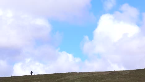 a man walks in the far distance of this beautiful shot of hiking in a remote place