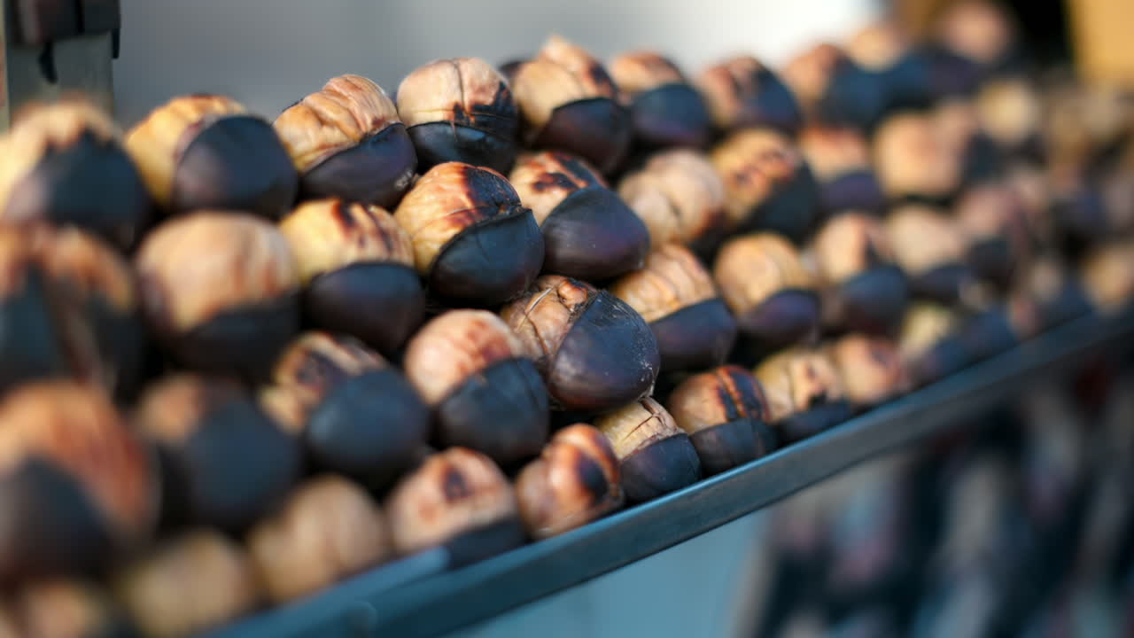 Close view of the turkish delight roasted chestnuts in a street shop in Istanbul, Turkey. Slow motion