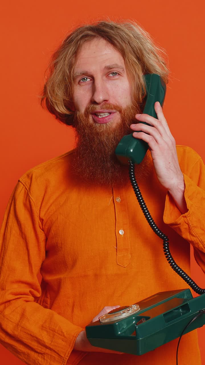 Man talking on wired landline vintage wired telephone of 80s hotline service operator conversation