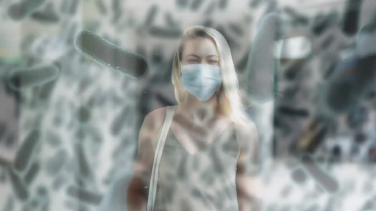 animación de células de covid-19 que se mueven sobre una mujer con máscara facial