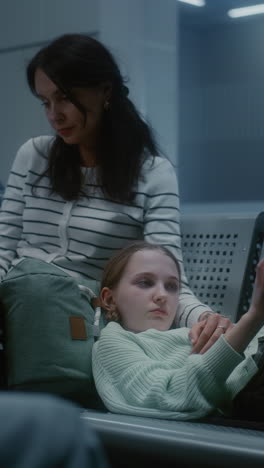 mother and daughter waiting at airport