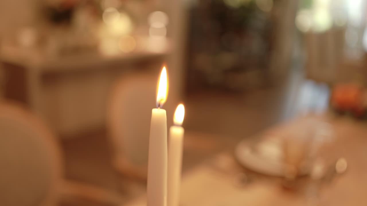 burning candles in soft warm ambient table setting atmosphere