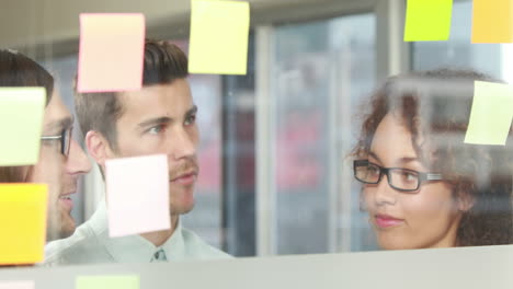 casual business team discussing about sticky notes