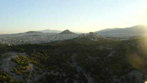 establishing shot of the city of athens, with acropolis and city park at sunrise, greece