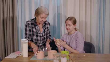 grandmother and granddaughter baking together