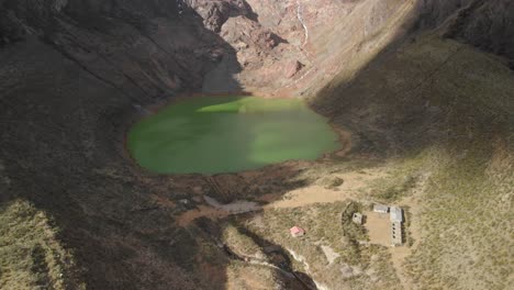 green lake in the peruvian andes, tilt up