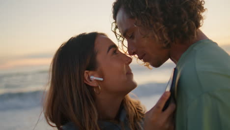 affectionate couple enjoying music dancing morning ocean closeup. lovers relax