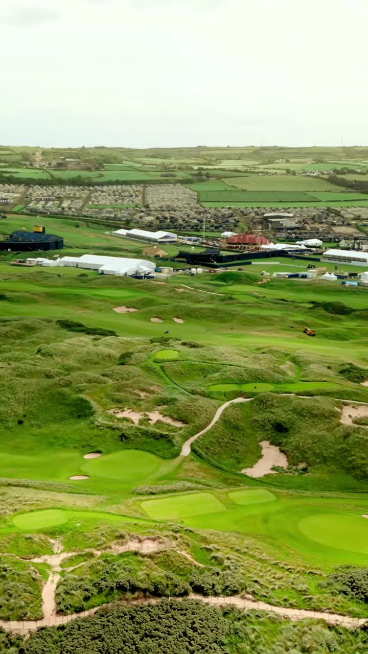 High and wide reversing social ratio aerial video of Royal Portrush Golf Course in County Antrim, Northern Ireland, UK. Produced in 1080x1920 vertical ratio, 60FPS and with Rec709 color