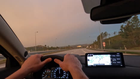 car traveler driving on highway using gps navigator