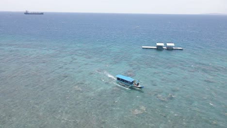 4k drone footage captures a stunning beach scene with crystal-clear waters, golden sands, gentle waves, and lush greenery along the shoreline, offering a tranquil and picturesque coastal escape