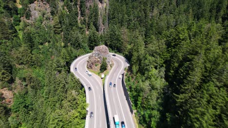 aerial view of traffic on an impressive curve in the mountains