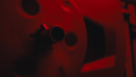 a close-up on a vintage tape recorder in a red blinking light