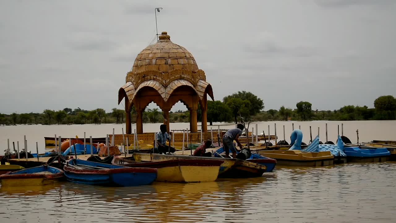 bunch of people extracting water from boats after heavy rainfall