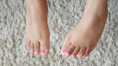 child's feet with painted toenails