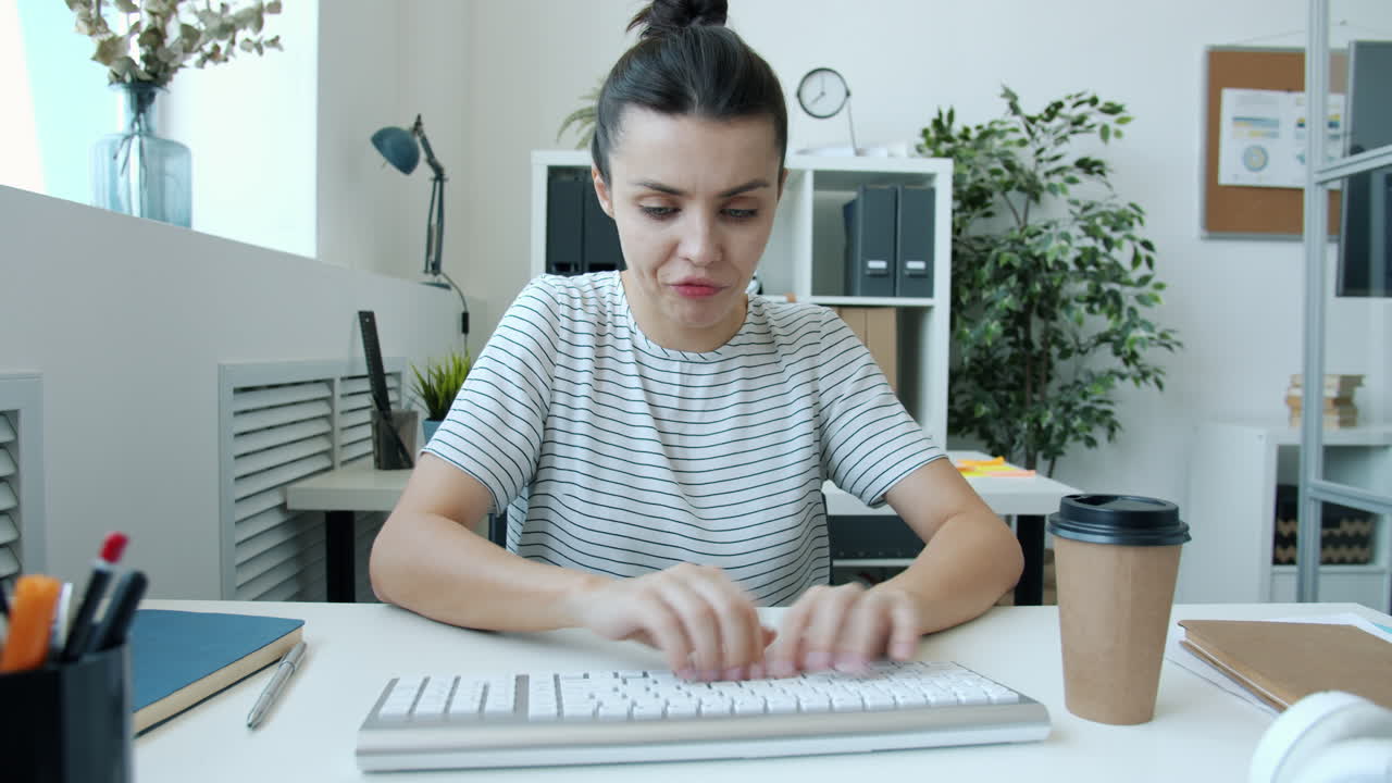Woman Stressed While Typing on Keyboard in Office