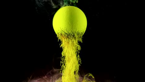 green ink paint slowly flows from the ball.