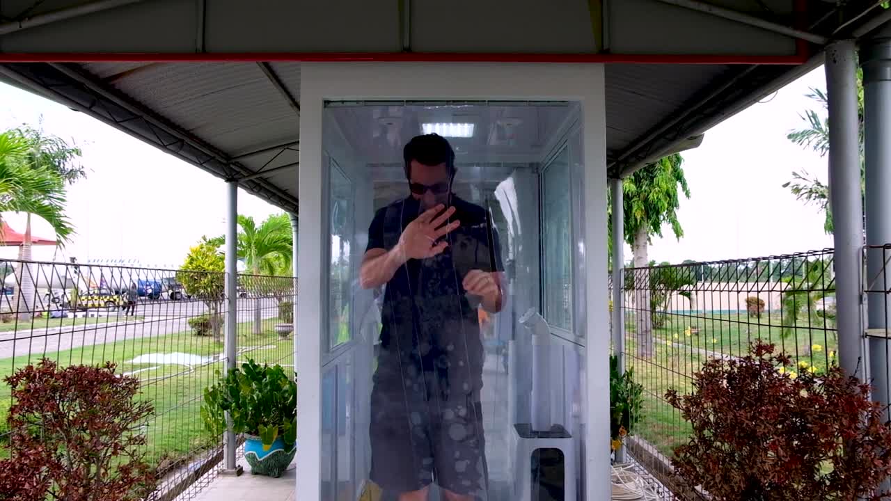 Travel during COVID pandemic arrival in new country airport border and immigration control with health temperature check and sanitised cleansing spray booth and disinfectant tunnel