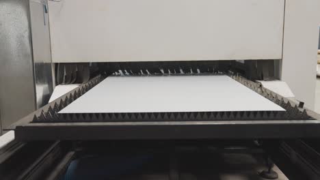 thin metal sheet sliding into computer numerical control machine for cutting