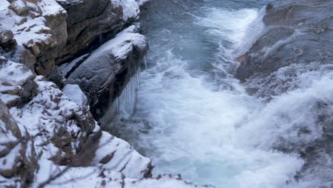 syterbacken frozen icy brook cascading down in hemavan, sweden - high angle close up