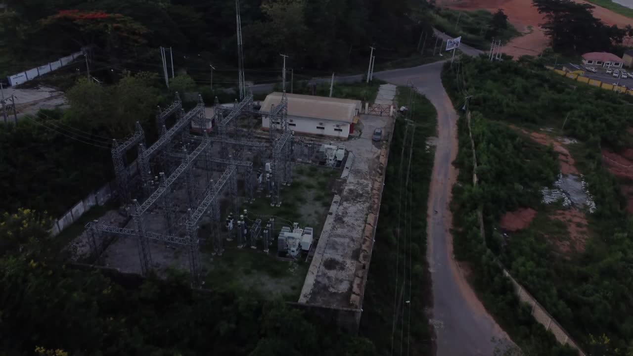 Drone flying towards a power grid substation in rural Nigeria, Africa