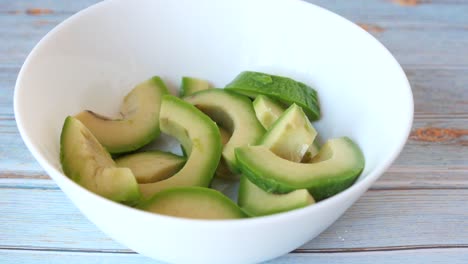 sliced avocado in a white bowl