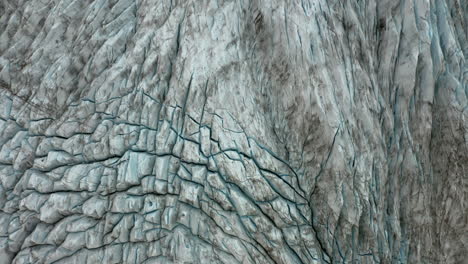 Aerial:-Top-down-panoramic-view-of-a-glacier-lagoon-edge-during-an-overcast-day