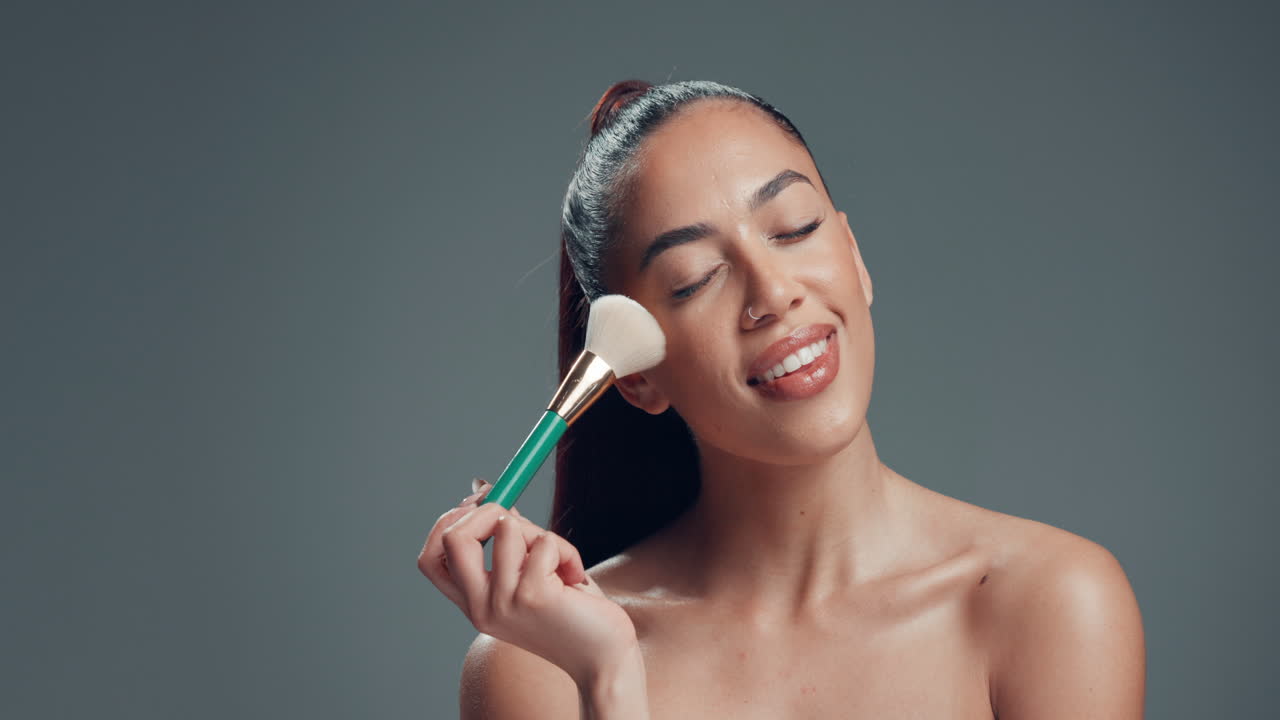 Woman applying makeup with a brush