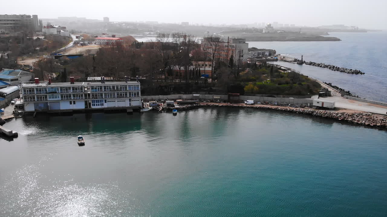 Coastal cityscape with boats and architectural buildings