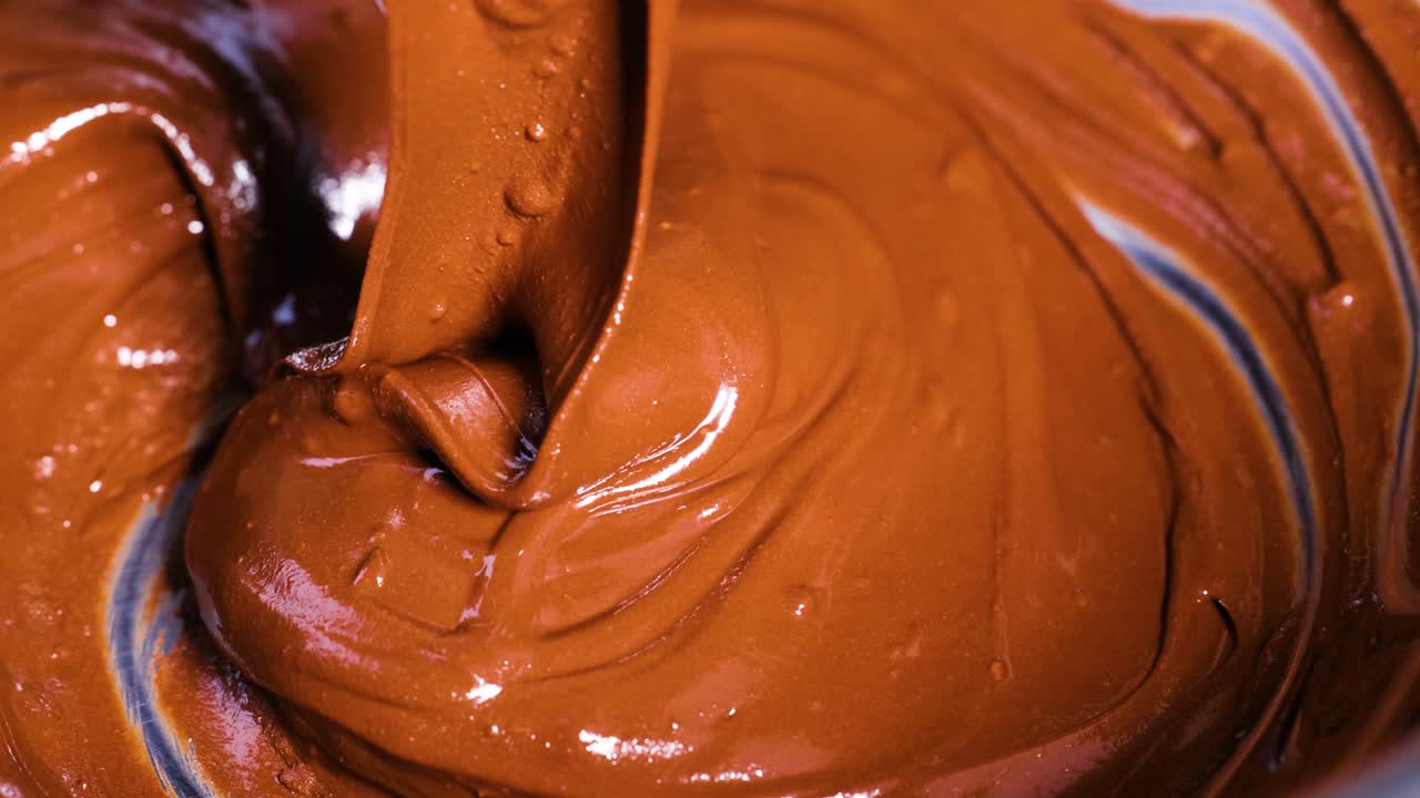 Rich chocolate being stirred and folded smoothly